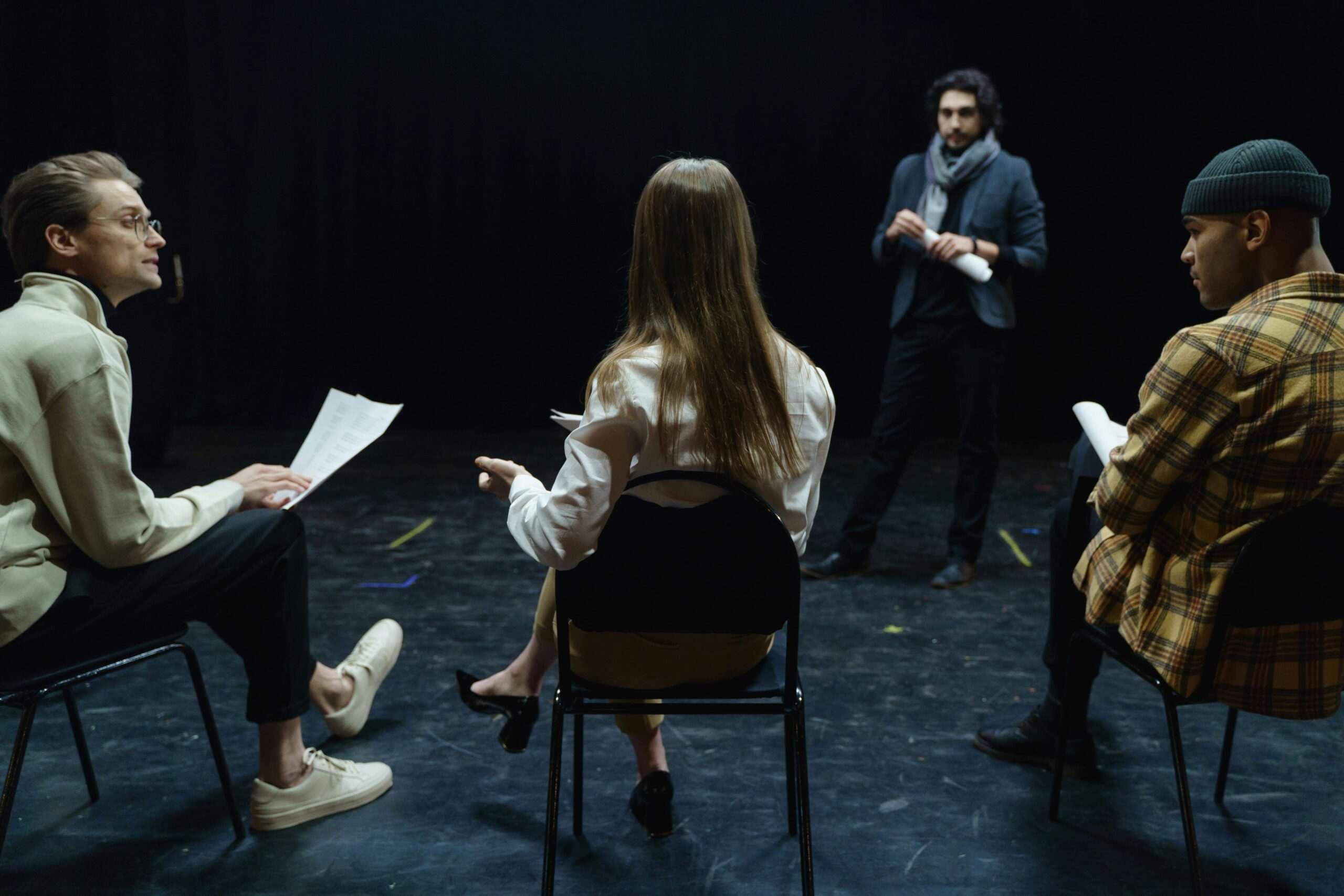 Community theatre audition workshop with participants learning a group song and dance together.