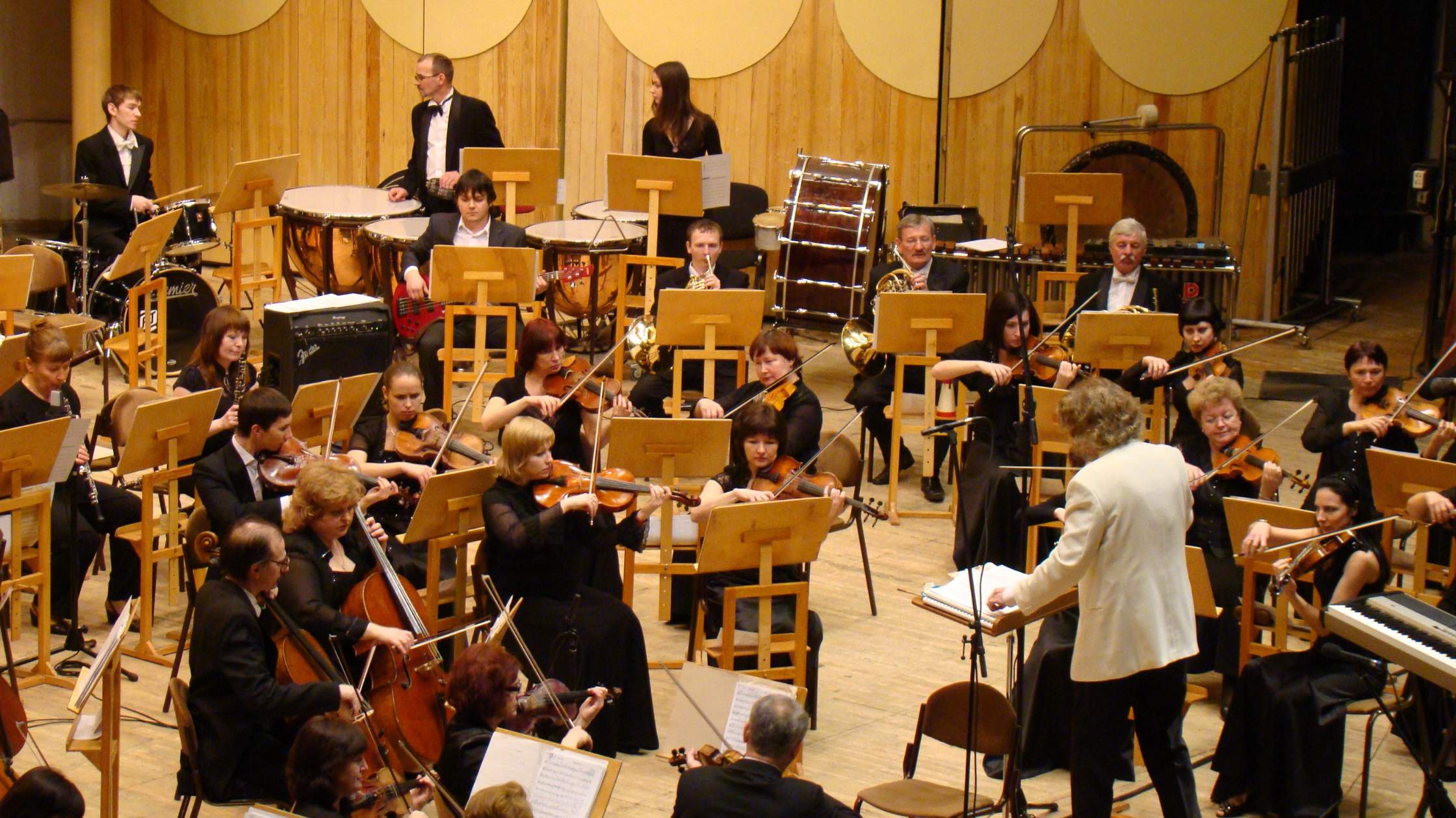 An orchestra getting ready to perform a concert